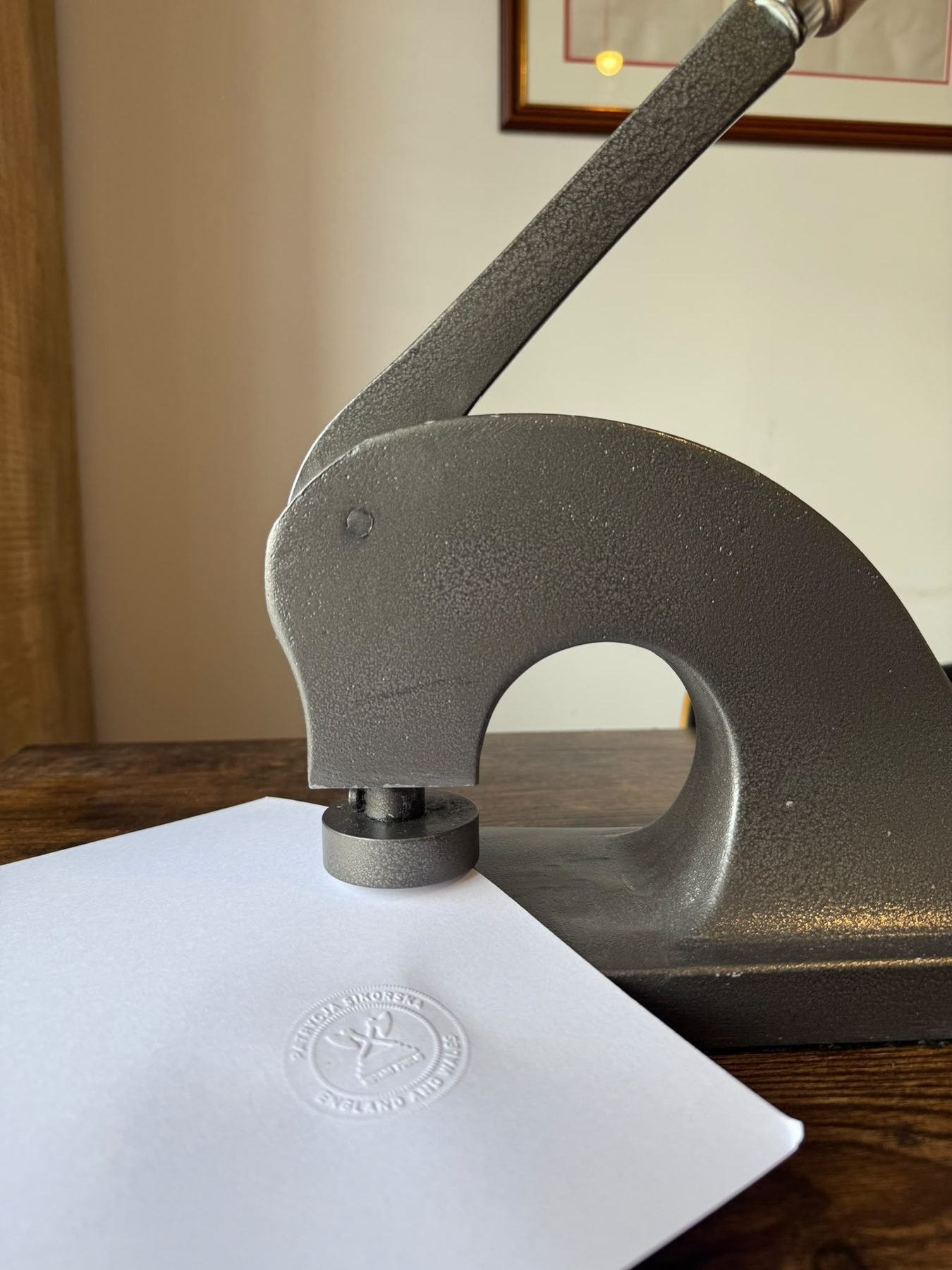 The notarial seal embossed onto a document by the press